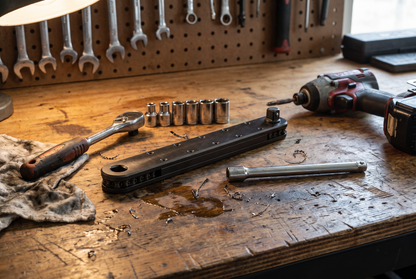 Extension Wrench 2.0 on a workbench beside a ratchet, sockets and impact driver